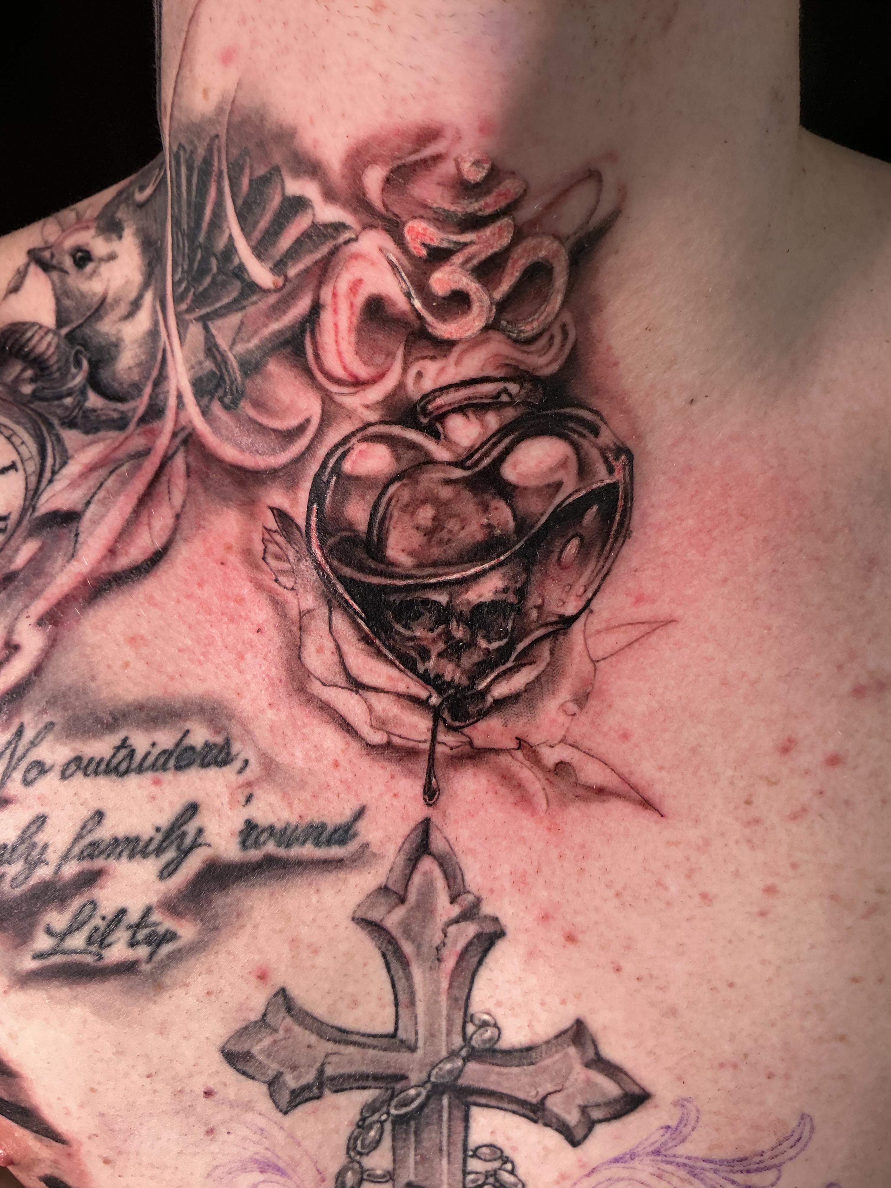 Large black and grey chest composition with rosary, watch, dove, and script