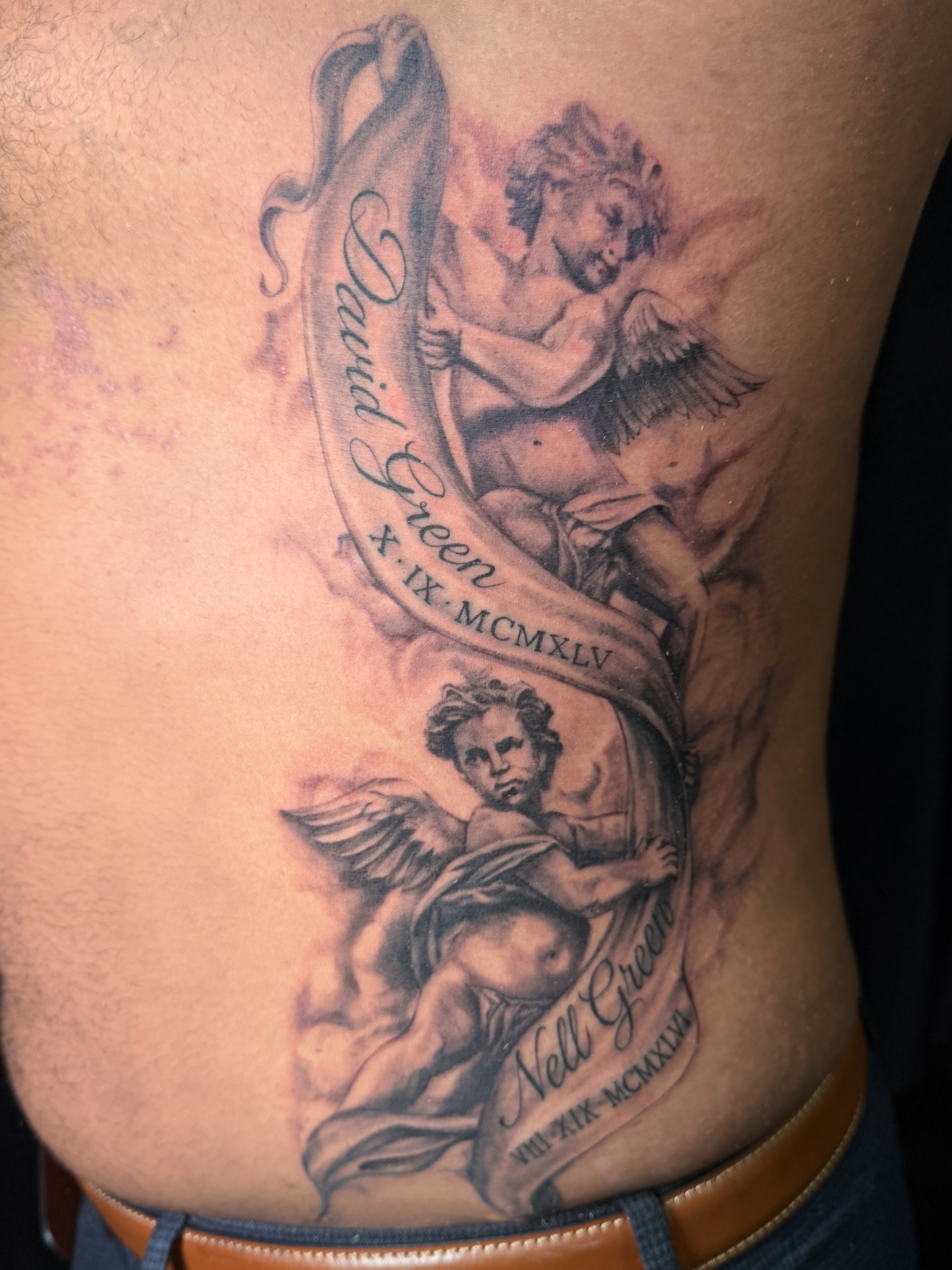 Large black and grey forearm tattoo