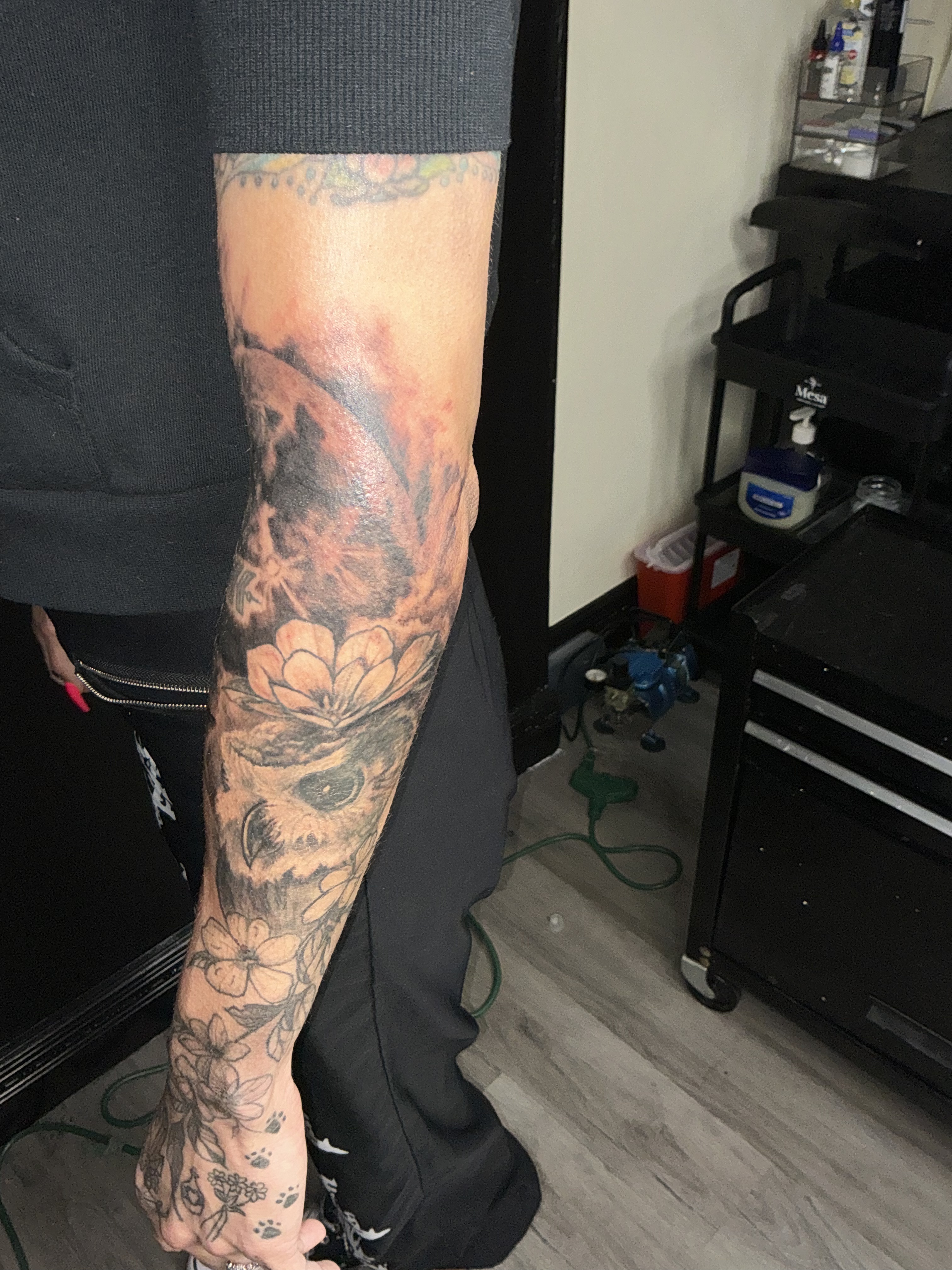 Large black and grey forearm tattoo