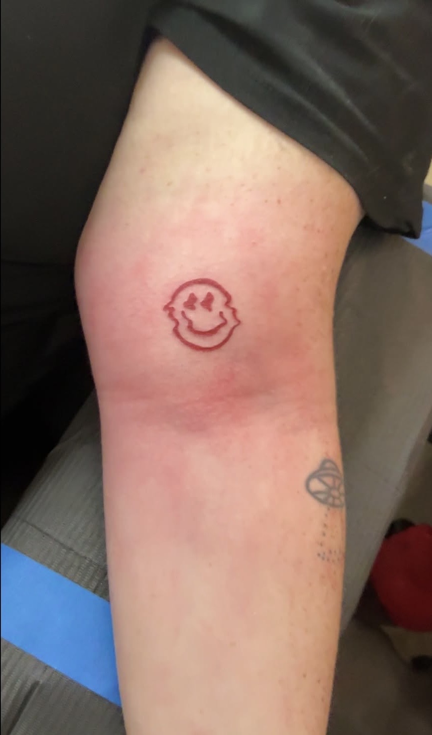 Fresh fine line smiley face tattoo — Hushtown Tattoos, serving Orange Park and Fleming Island