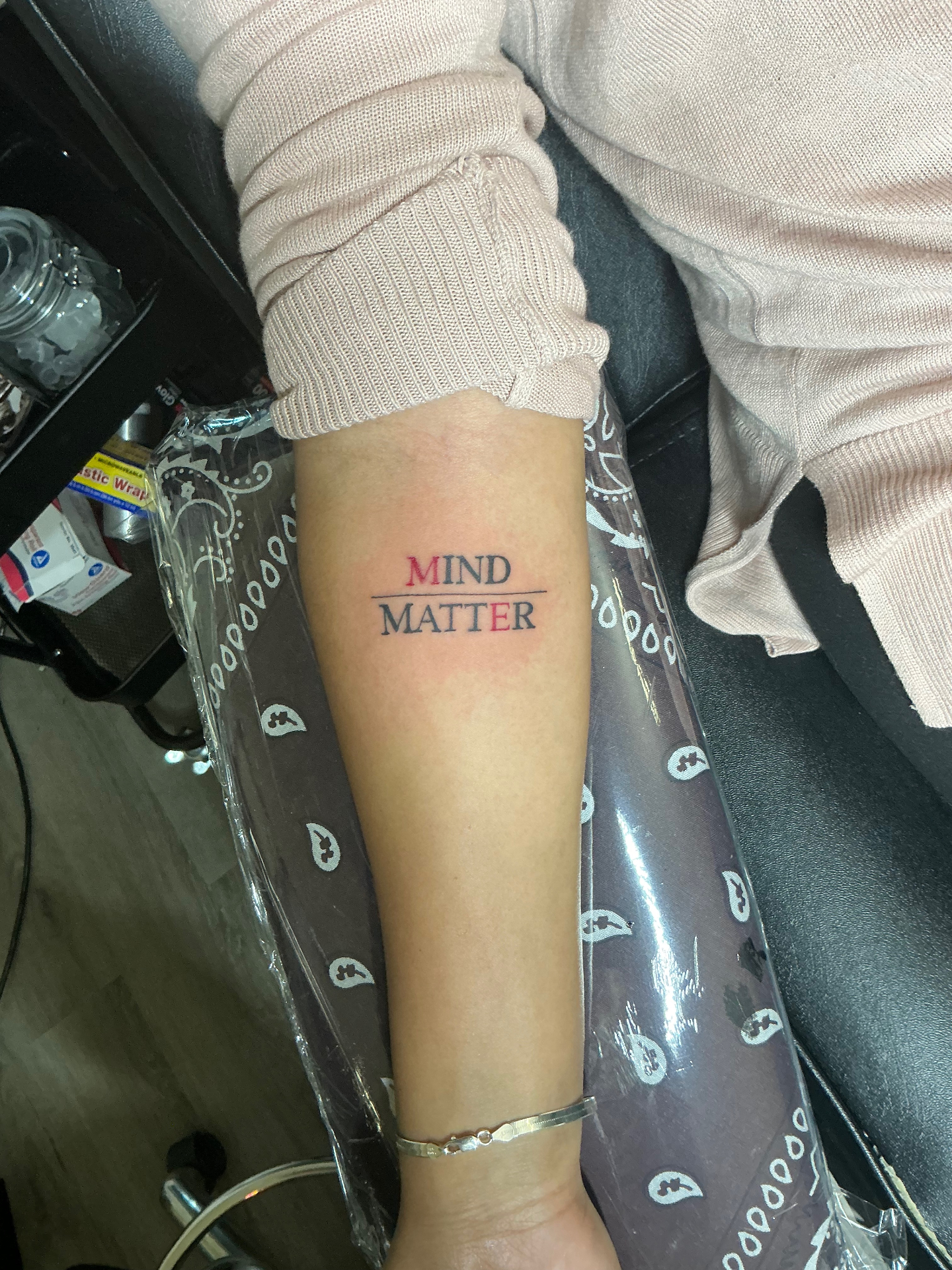 Mind Matter typography tattoo in red and black