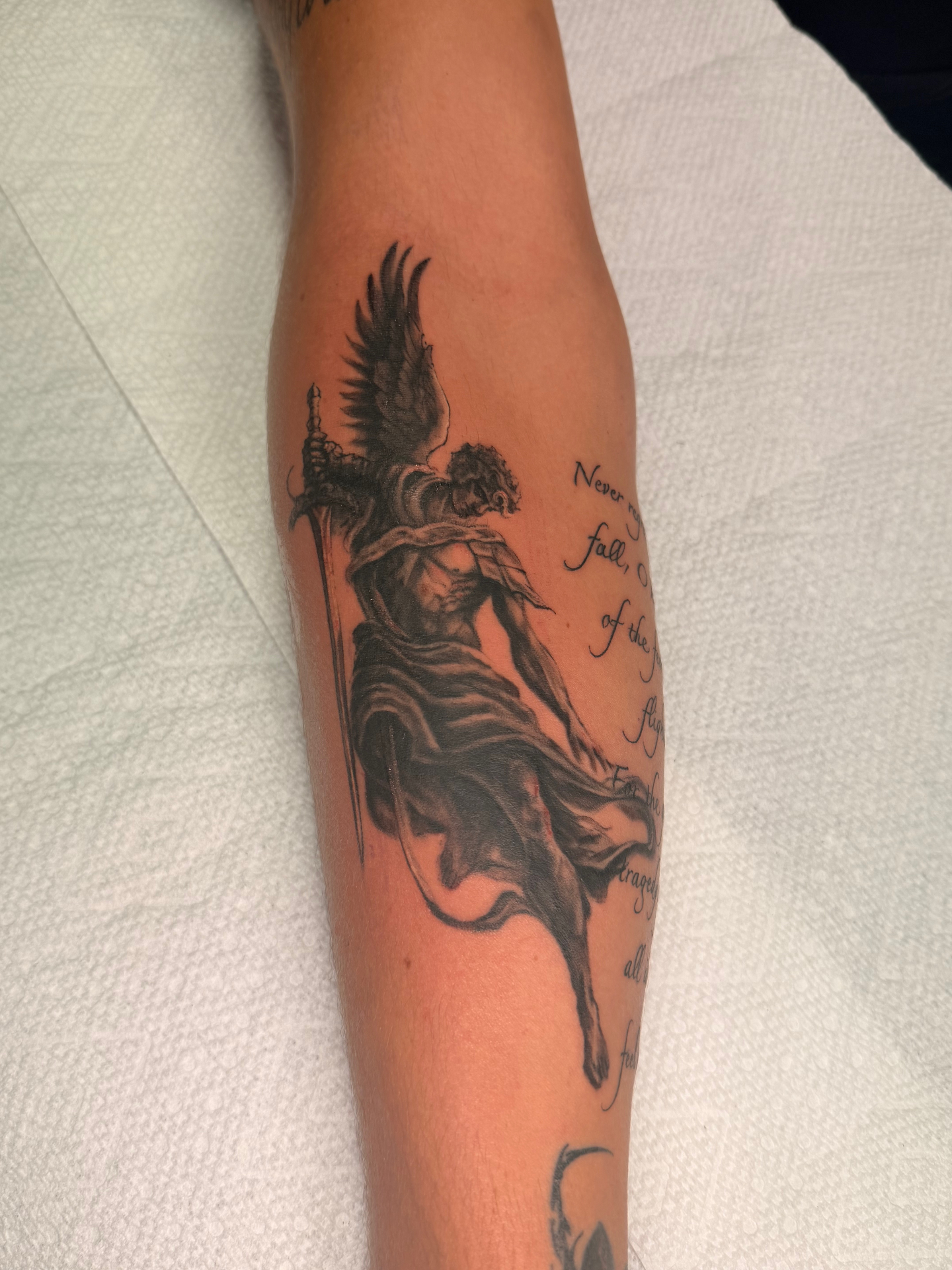 Black and grey fallen angel forearm tattoo detail inspired by Icarus