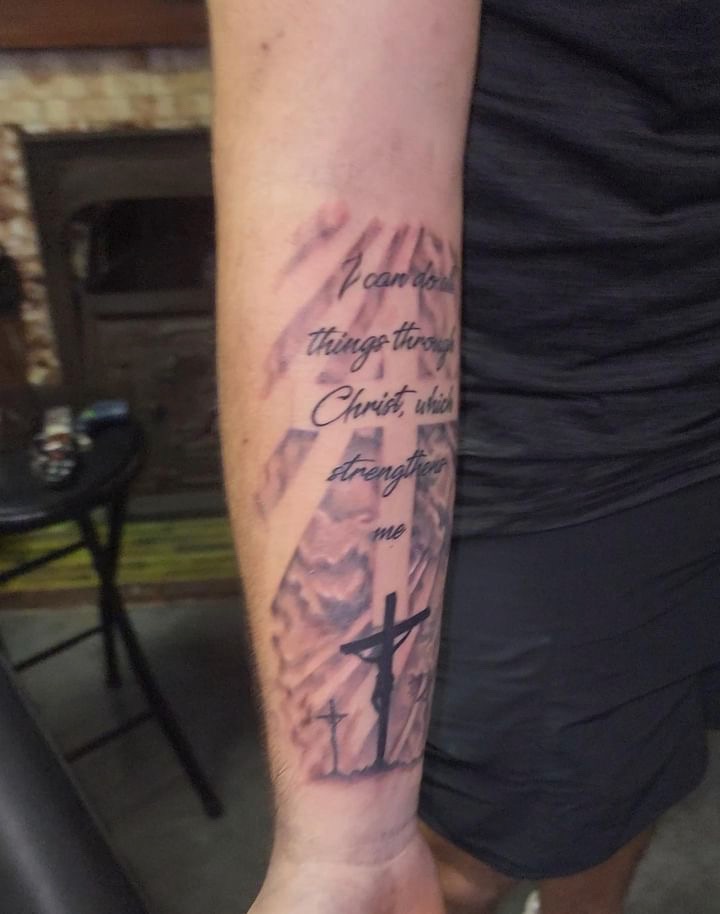 Cross with scripture lettering forearm tattoo