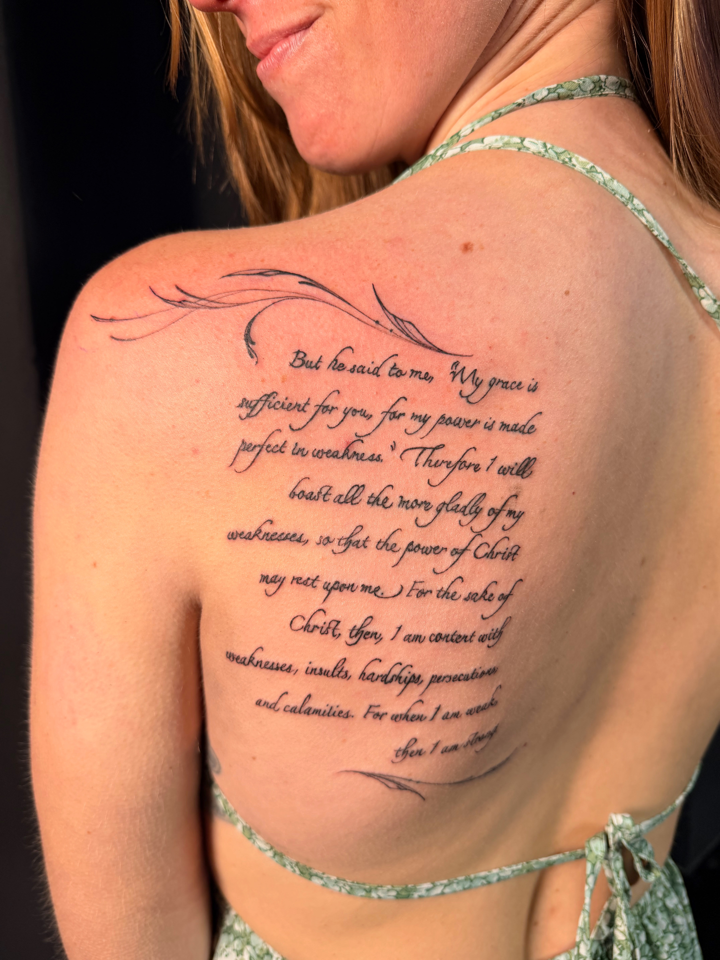Large scripture back tattoo with ornamental flourishes