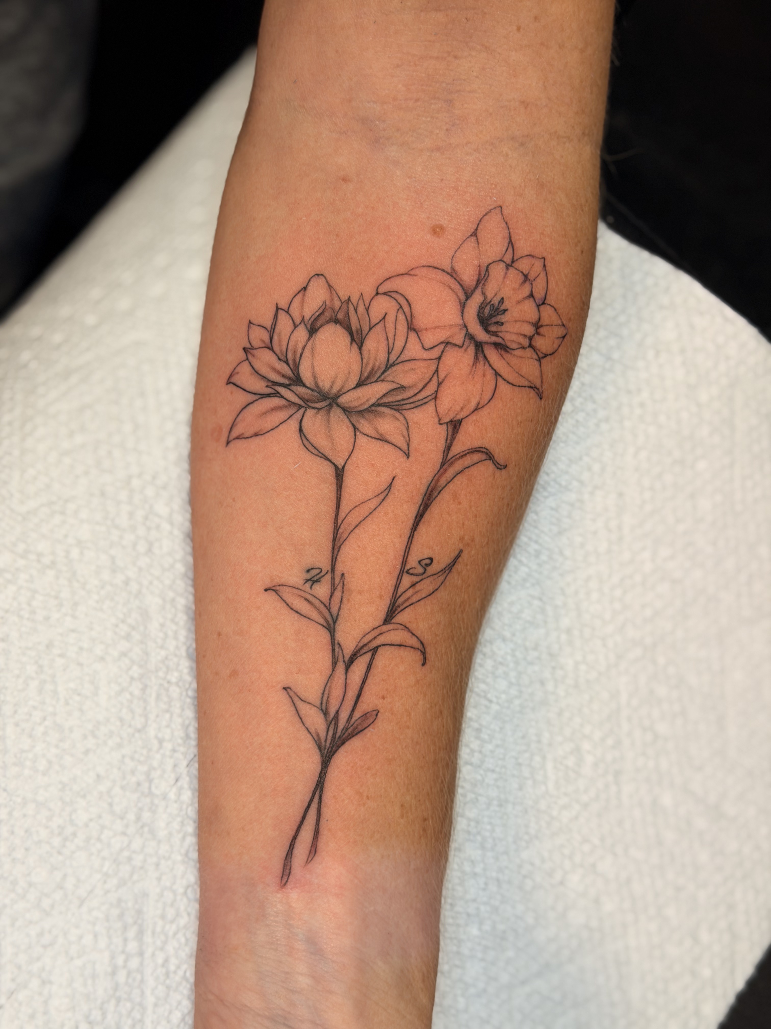 Ornamental black and grey forearm tattoo