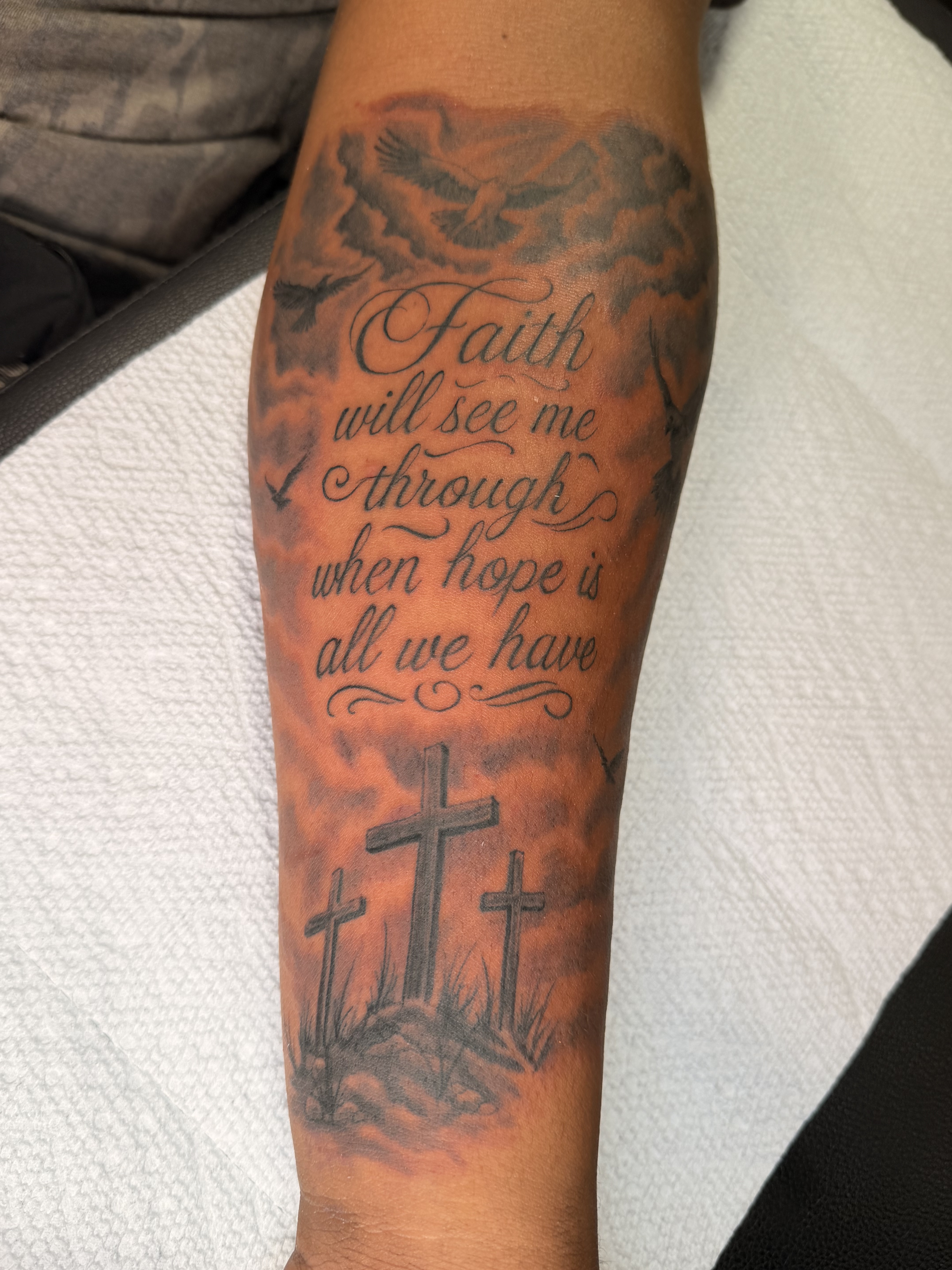 Large black and grey forearm tattoo