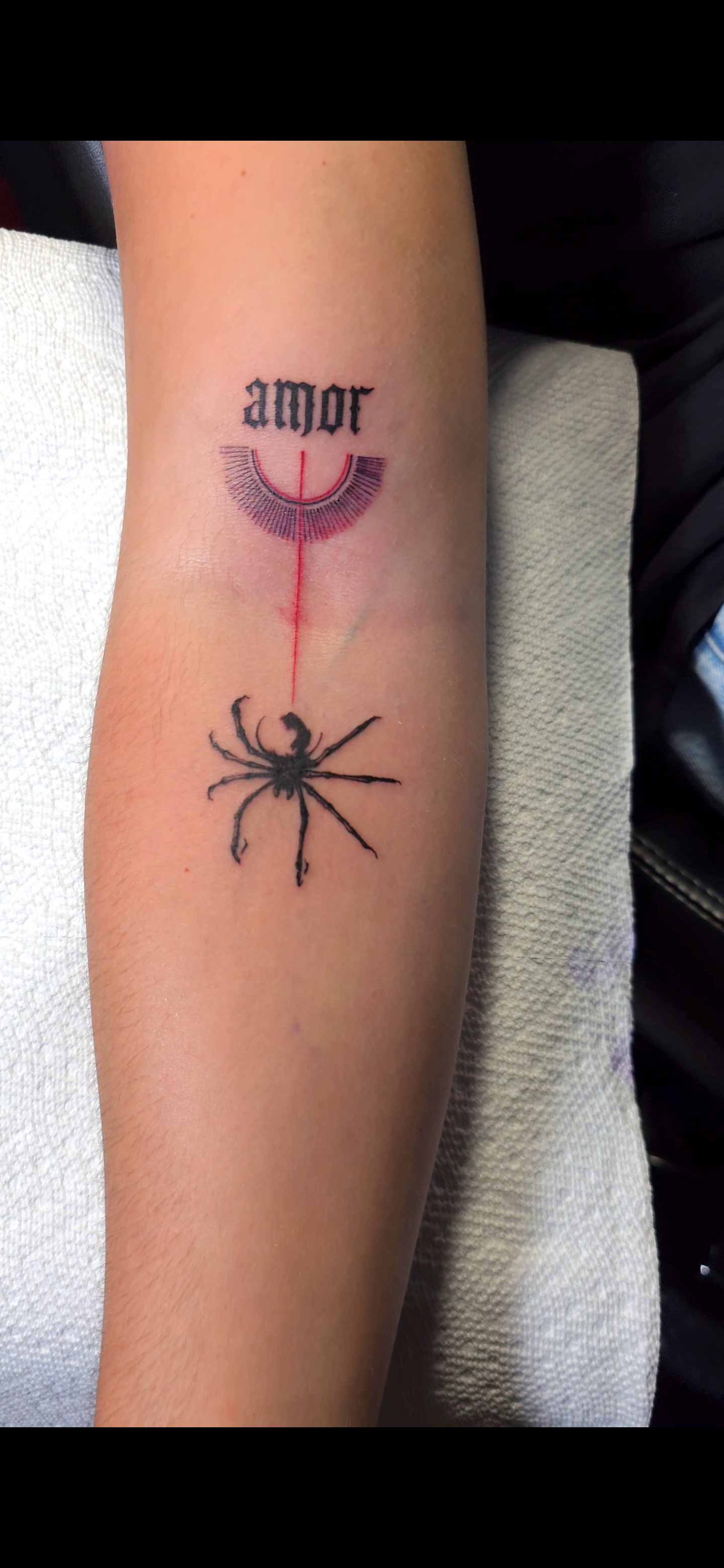 Small illustrative tattoo on the forearm