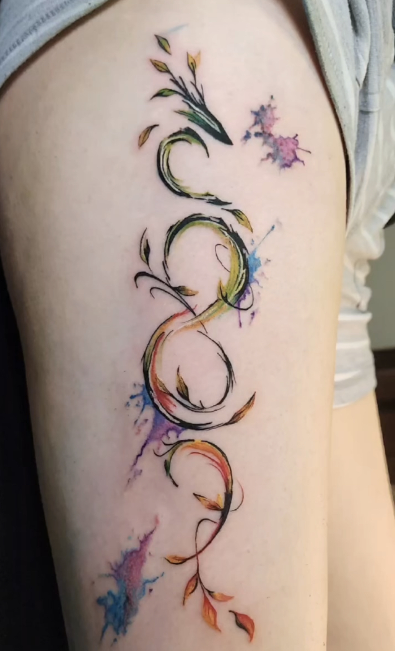 Fine line moon and floral arm tattoo
