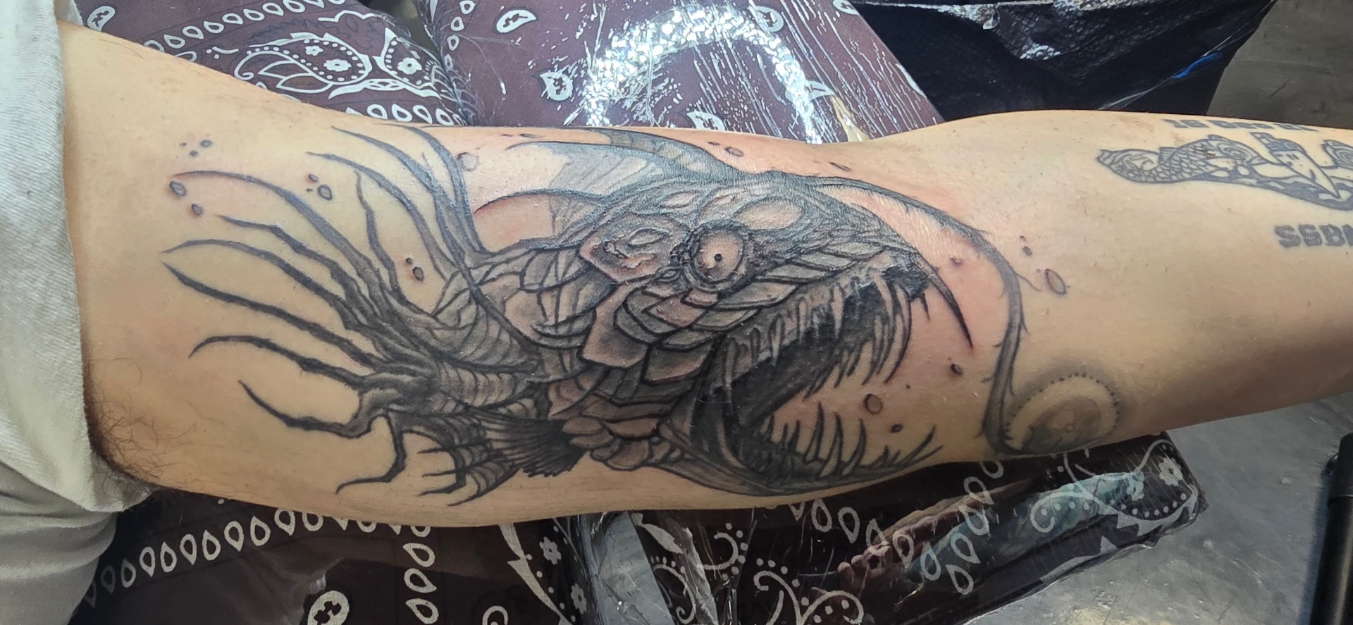 Black and grey Asian dragon forearm tattoo
