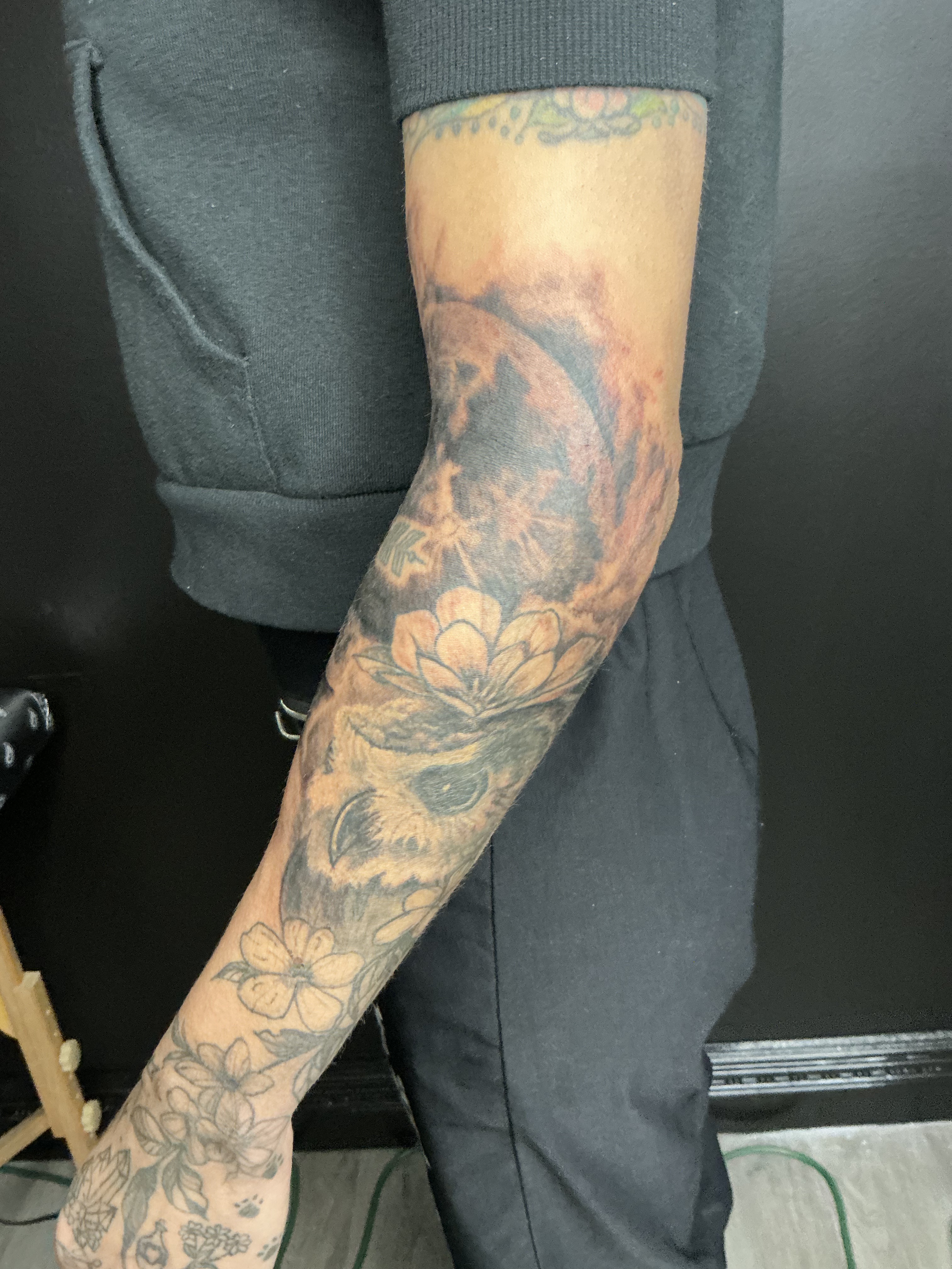 Large black and grey forearm tattoo