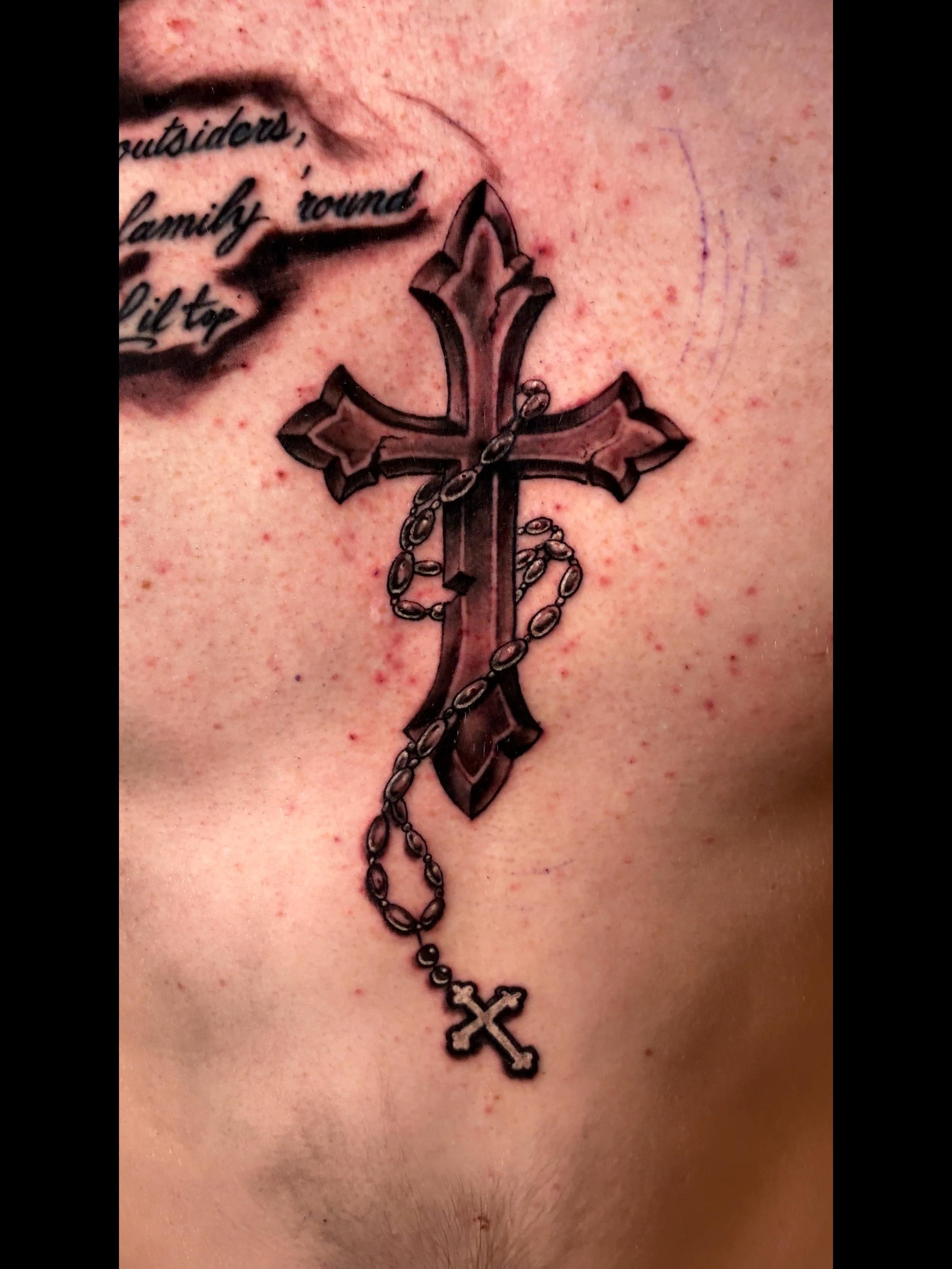Black and grey cross torso tattoo