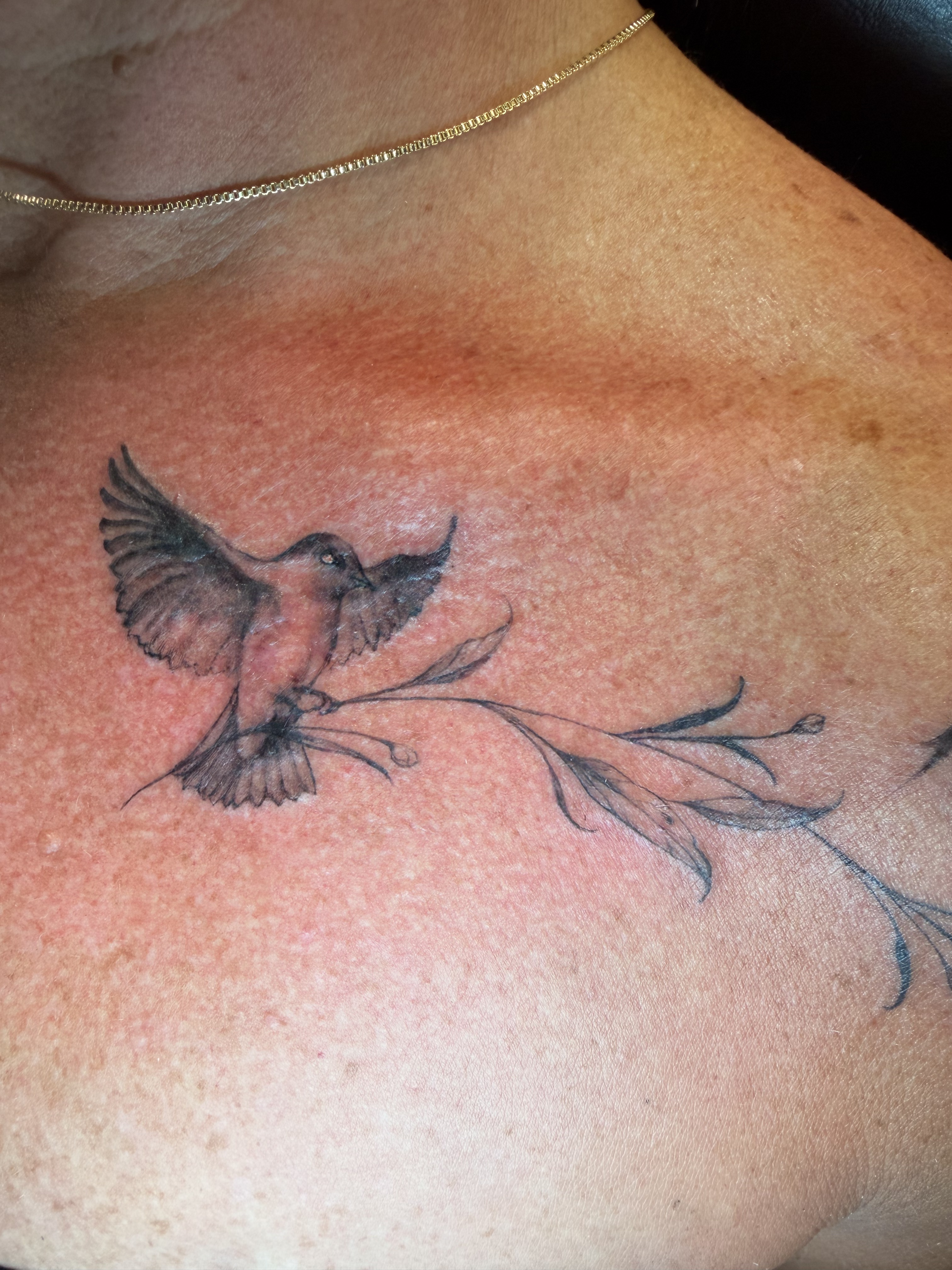 Ornamental black and grey forearm tattoo