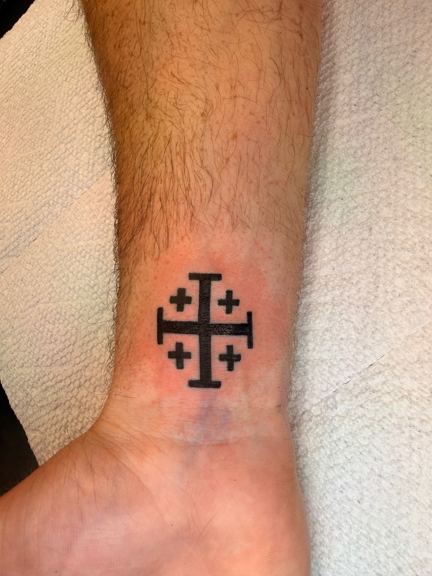 Bold black Jerusalem cross wrist tattoo