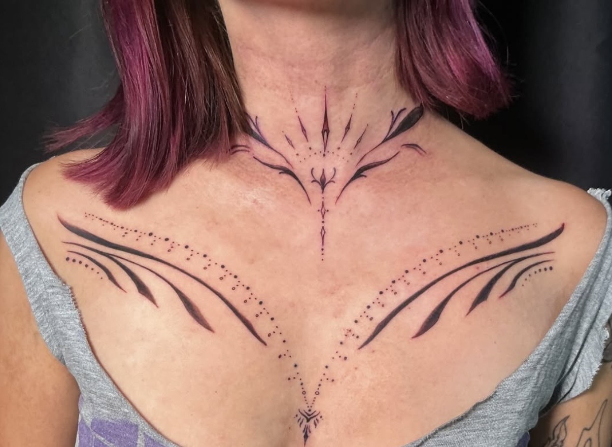 Ornamental sternum and chest decorative linework tattoo