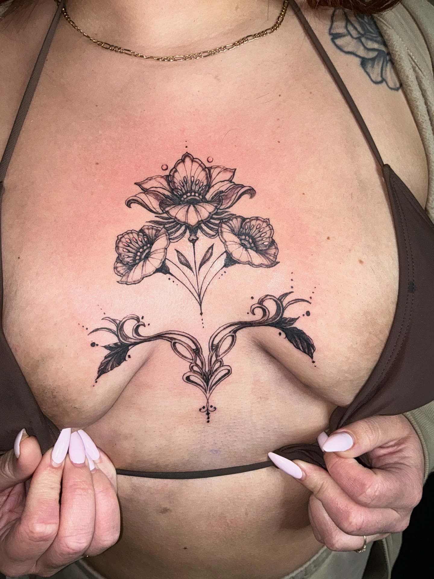 Fine line floral ornamental sternum tattoo