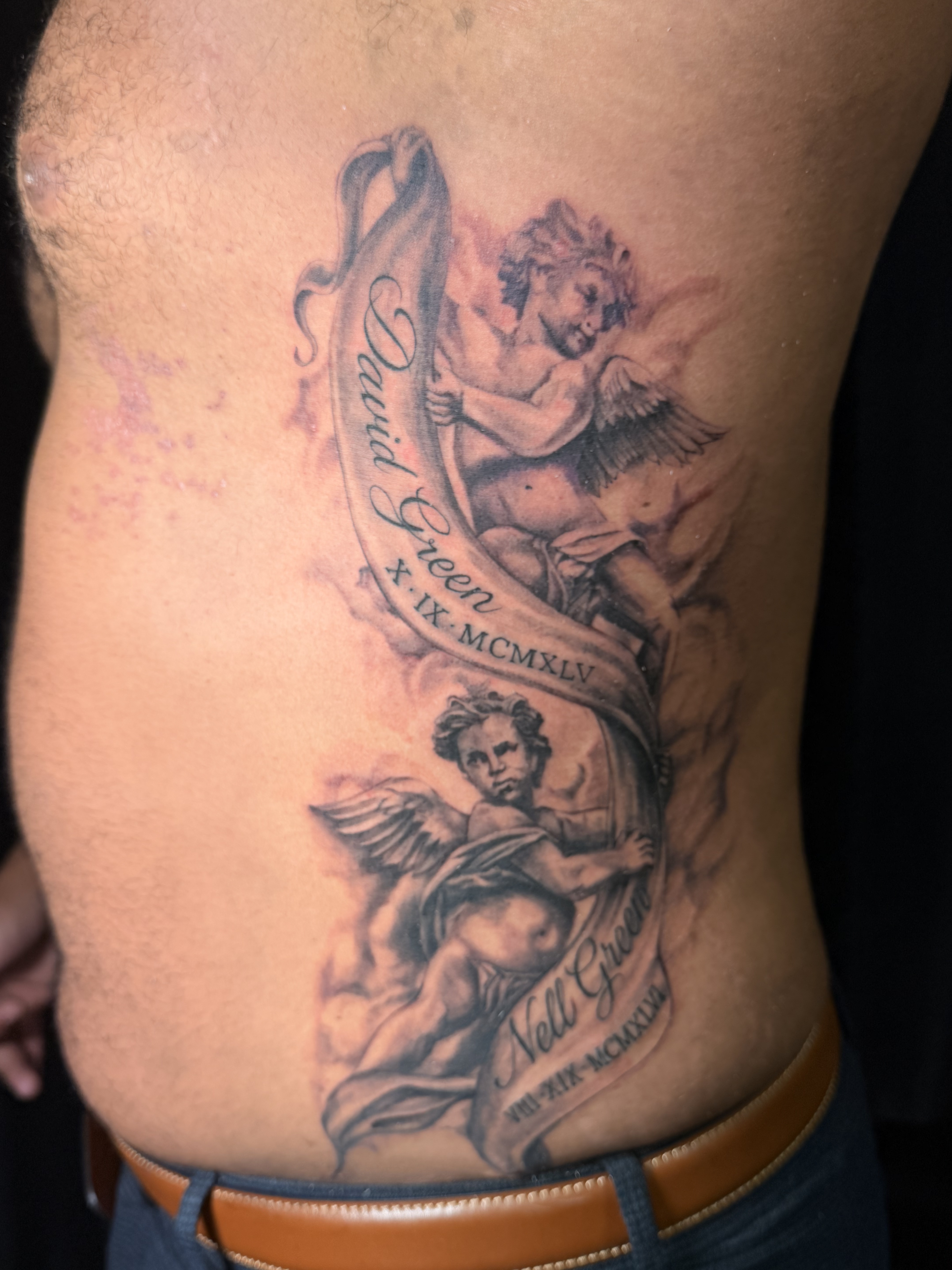 Large black and grey forearm tattoo