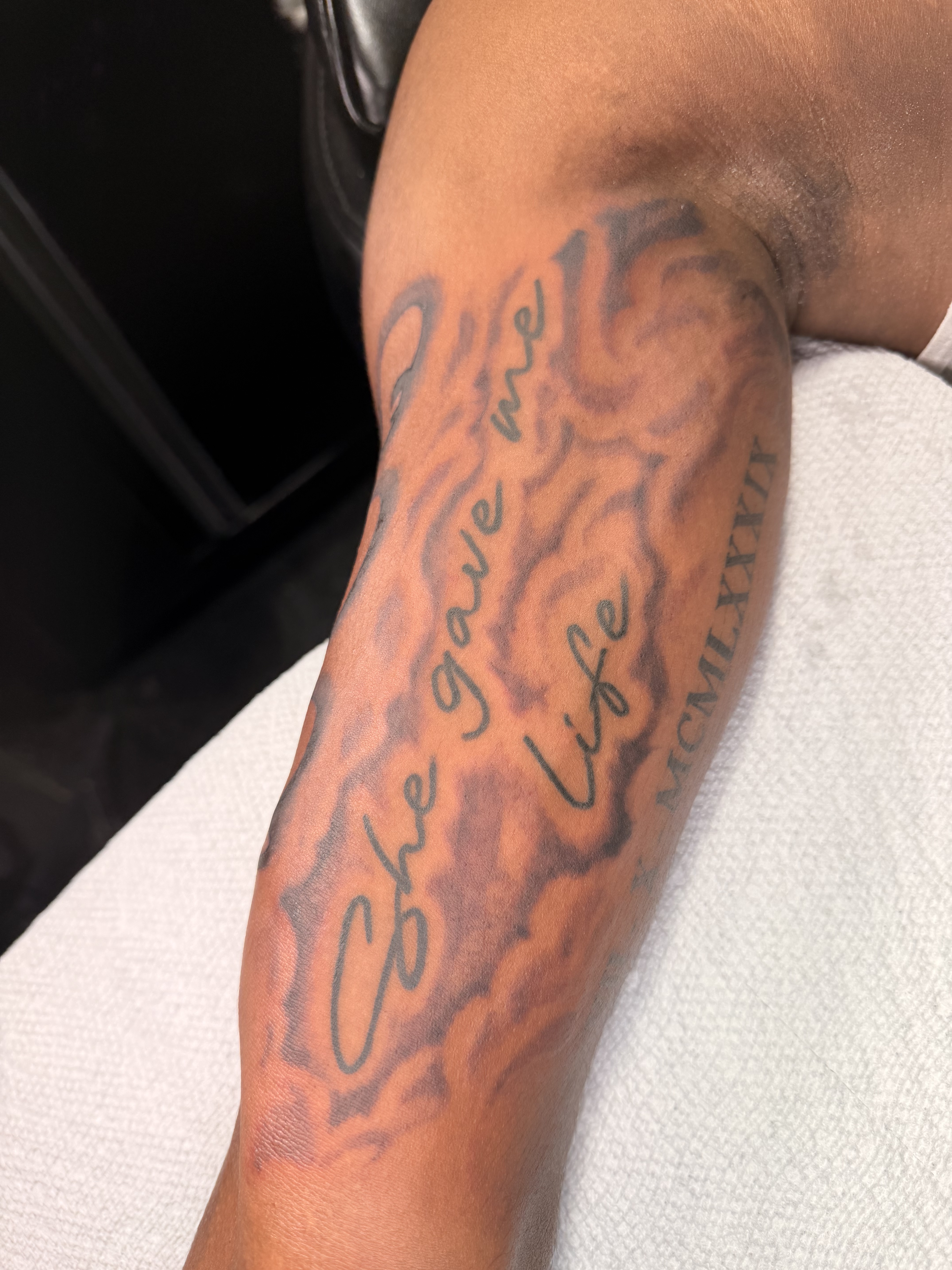Large black and grey forearm tattoo